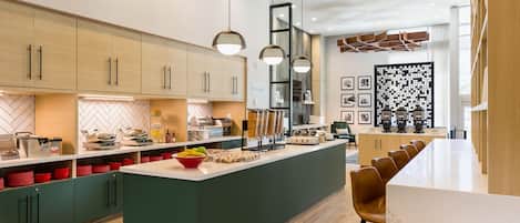 A modern kitchen with a central island, wooden cabinets, and pendant lighting.