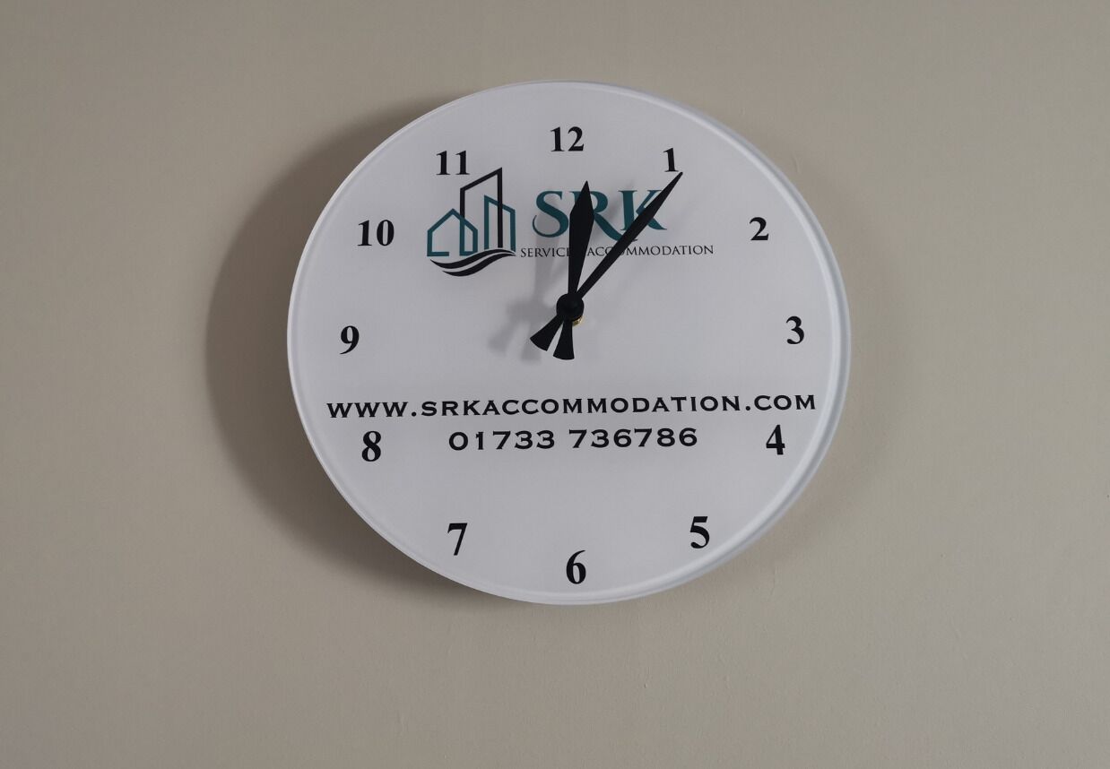 A wall clock with the logo "SRK" and the website "www.srkaccommodation.com".