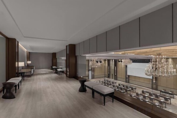 A modern hotel lobby with a long reception desk, seating area, and a chandelier. - Courtyard by Marriott Phuket Town (Phuket)