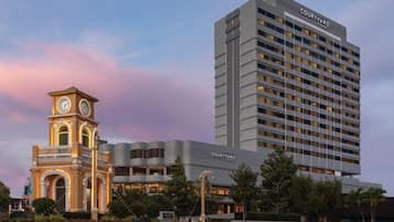 A hotel with a clock tower and a modern building with 'COURTYARD' signage.