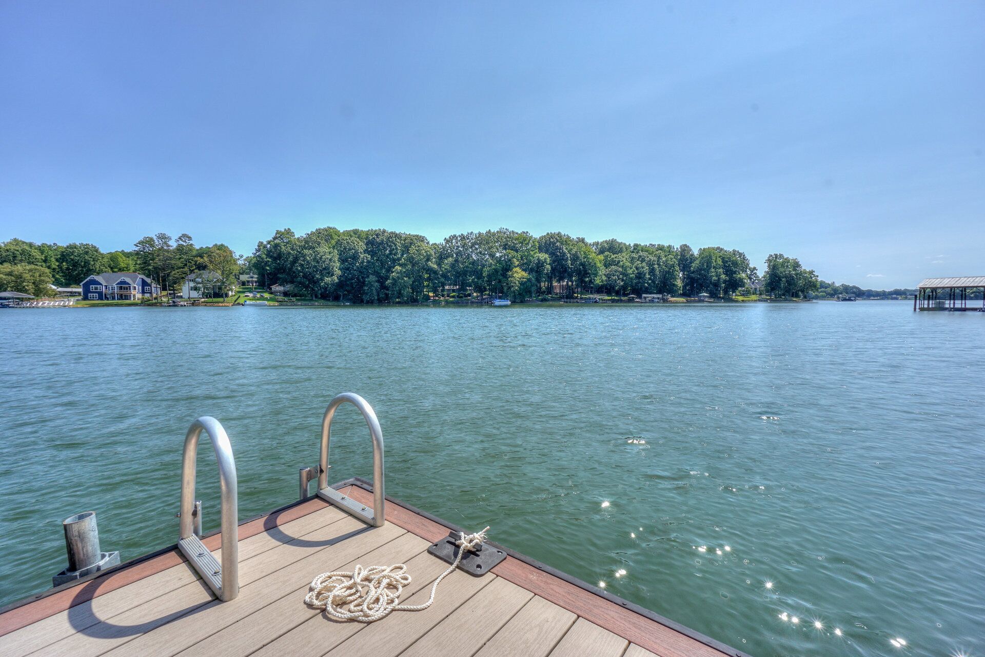 A wooden dock with metal railings and a rope.