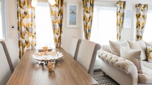 Un comedor con mesa de madera, sillas y un centro decorativo.