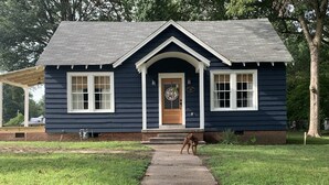 A two-story house with a dark blue exterior, white trim, and a front porch. - Rustic retreat — Car Service Available to& from Oxford, Tunica, Memphis (Sardis)