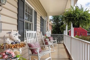 Relax on the porch with heart-patterned cushions and enjoy the serene surroundings.