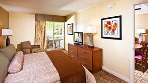 A hotel room with a bed, a desk, a chair, a television, and a dining area with a table and chairs. - Enjoy beautiful beaches of Del Mar, minutes to San Diego. Walk to restaurants.  (Solana Beach)