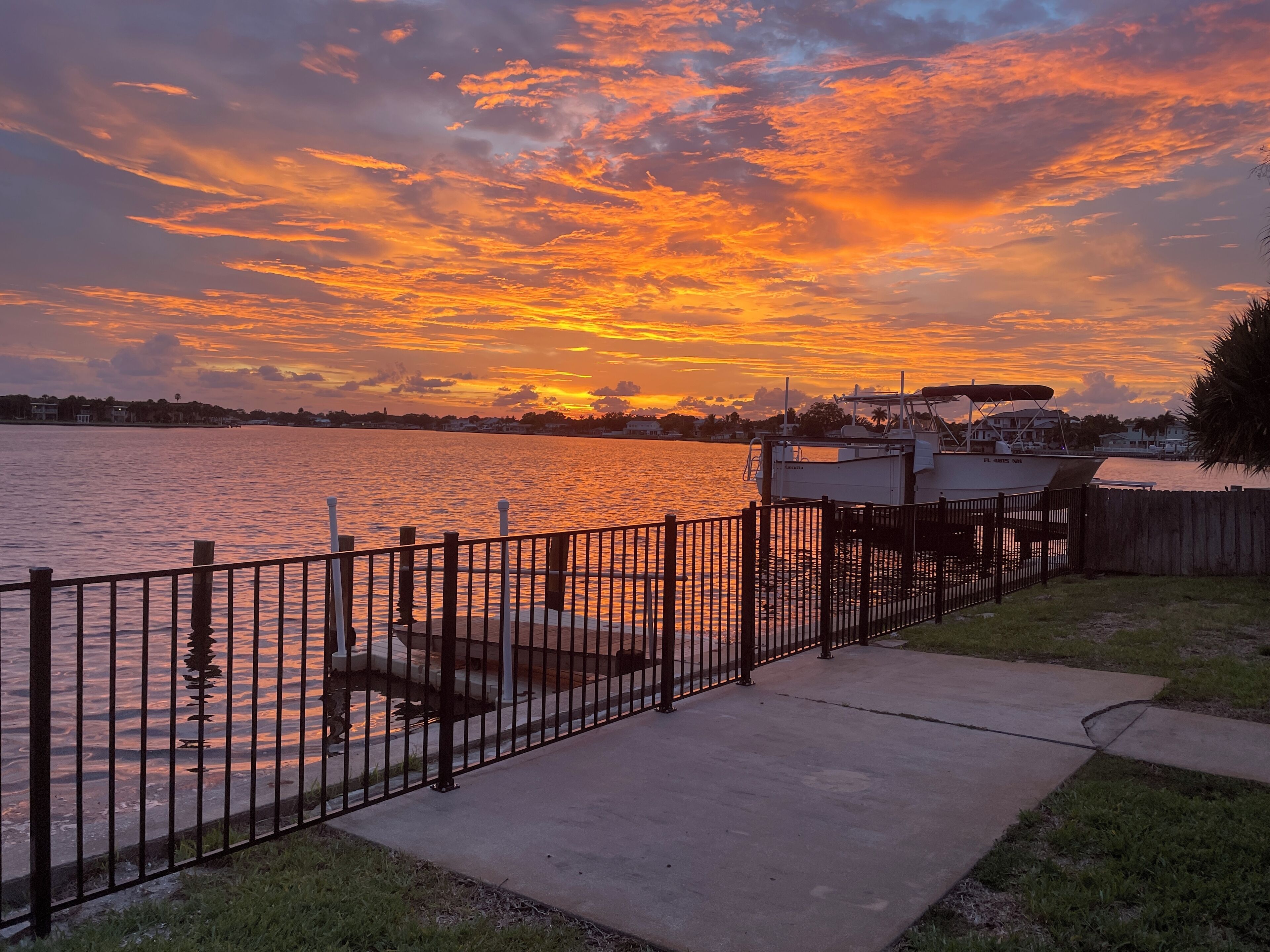 Charming waterfront home with covered patio, dock and large fenced in yard