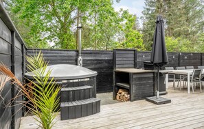 A wooden deck with a barbecue area, including a grill and seating. - 4 bedroom lovely home in Knebel (Knebel)