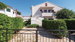 A two-story building with a staircase leading to the upper floor. - Nice Home in Pag With Wifi and 2 Bedrooms (Pag)