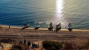 On the beach, sun loungers, beach towels