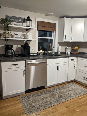 Enjoy a convenient kitchen with a coffee maker, kettle, and sink, perfect for quick breakfasts or coffee breaks.
