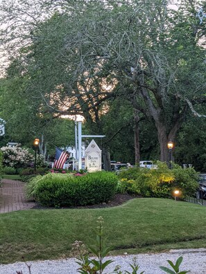 Welcome to the Belfry Inn & Bistro, surrounded by lush greenery and mature trees.