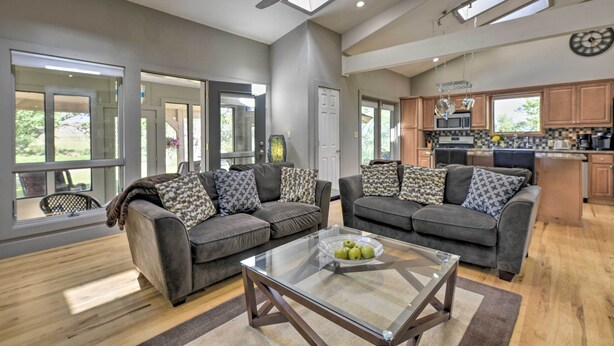 A spacious living area with two grey sofas, a glass coffee table, and a ceiling fan. - Serene Mountain Retreat w/ Patio & Mtn Views! (Cortez)