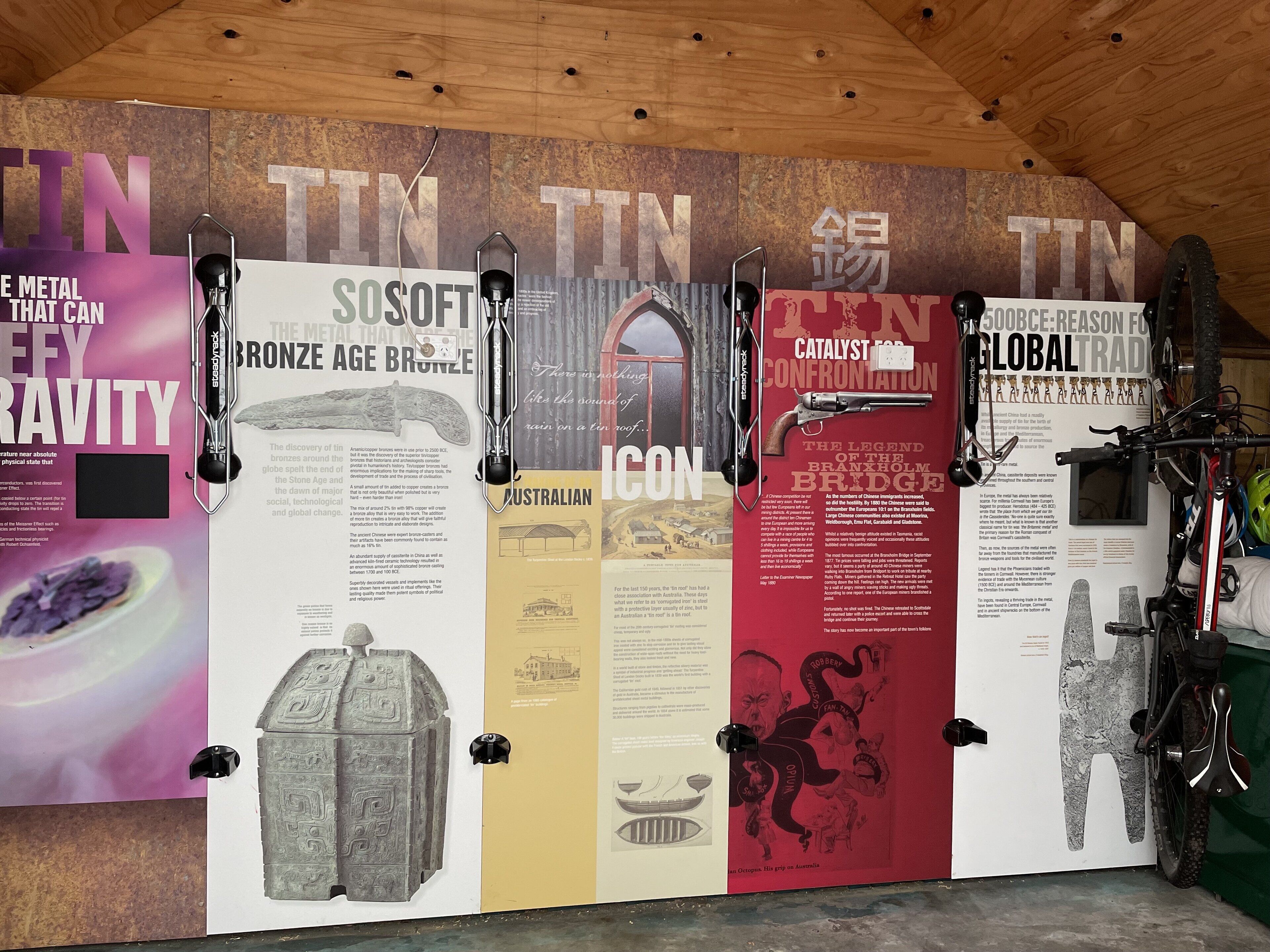 A wall with informational posters about metal, including Bronze Age Bronzes and the Brindisi Bridge.