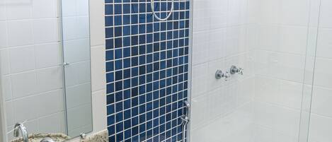 A bathroom with a sink, toilet, and shower.