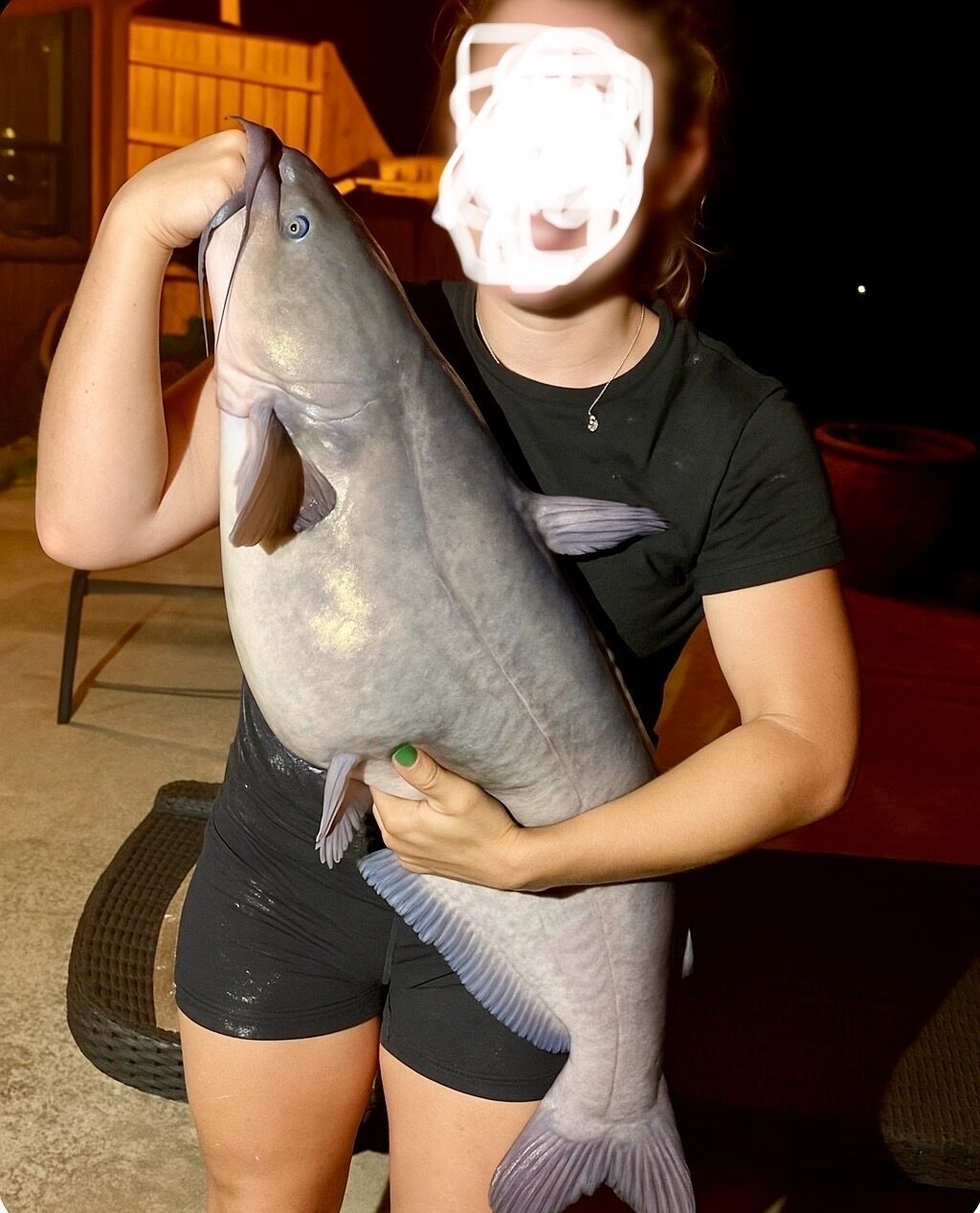 A person holding a large fish.