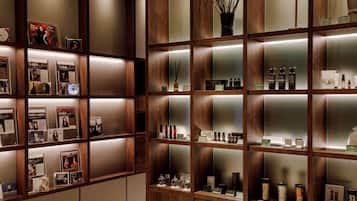 A well-organized display of books and toiletries in a wooden shelving unit.