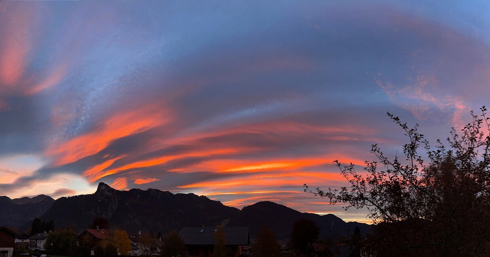 A mountainous landscape with a sunset sky.