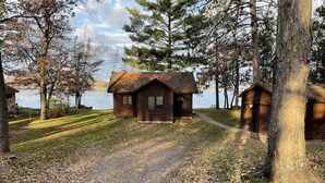 A cabin with a dirt path leading to it, surrounded by trees and a lake. - FALL DATES OPEN! Lakeside Cabin - Sandy Beach & Amazing Lake View! (Hillman)