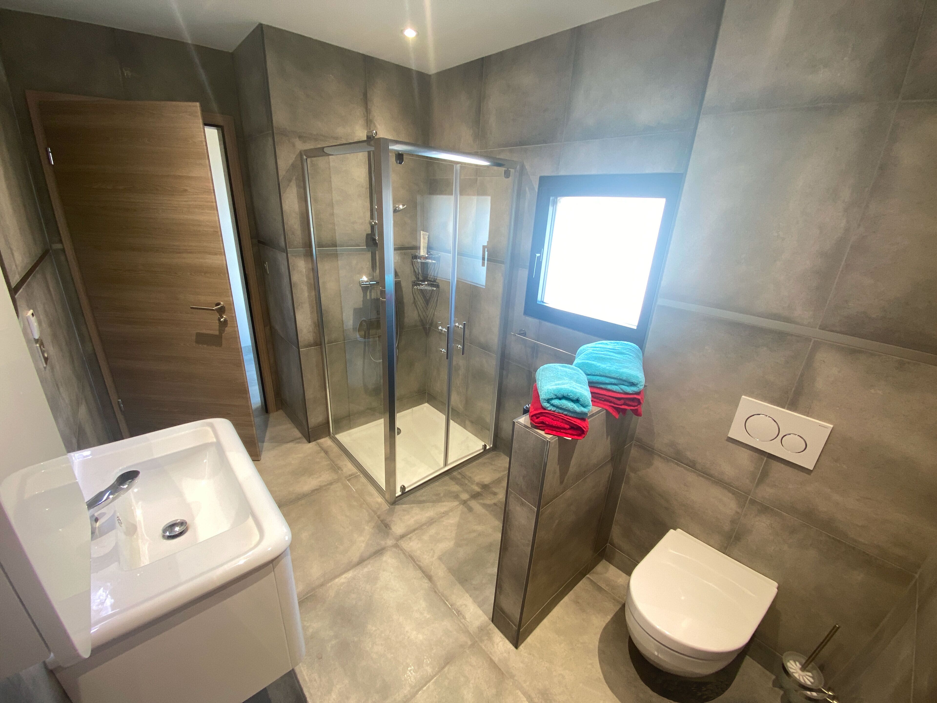 Shower, hair dryer, towels, soap