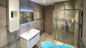 A modern bathroom with a glass-enclosed shower, a white vanity, and a mirror with LED lighting. - Chambre D'hôtes sur Domaine Viticole Proche Colmar Eguisheim sur Route des Vins (GUEBERSCHWIHR)