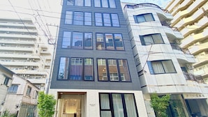 A modern hotel building with a glass facade, multiple floors, and a prominent entrance. - Ikoi Hotel Tokyo (Tokyo)
