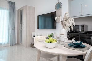 Enjoy meals in this well-appointed dining area with a large flat-screen TV and kitchenette.