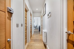 Stylish hallway with doors, radiator, and artwork.