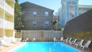 A rectangular swimming pool with lounge chairs and a wooden fence. - New Listing!  Modern studio ocean block with a pool (Ocean City)