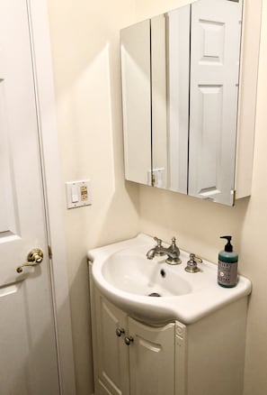 Bathroom with a sink, mirror, and single faucet.