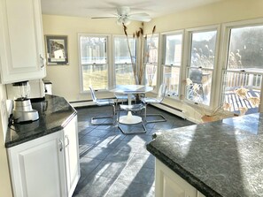 Enjoy meals in this well-lit kitchen with a blender, dining area, and round table.