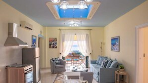 A compact living space with a kitchenette, dining area, and seating area. - Palaiochora Retreat - Sea Sunset Rooftop (Avia Kalamata)
