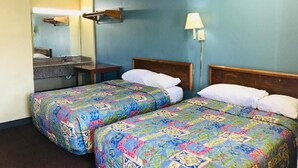 A hotel room with two beds, a bathroom, and a nightstand. - Roosevelt inn Motel (San Antonio)