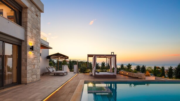 A modern poolside area with a glass-enclosed room, a canopy, and a bed with a canopy. - Perfect Hideaway for Families & Unmatched Sunsets (Rethymno)