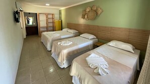 A hotel room with two beds, a wooden headboard, a wall-mounted basket, and a small table. - Mutá Praia Hotel (Porto Seguro)