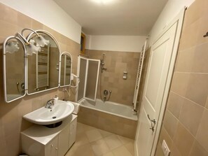 Kombination af bruser/badekar, hårtørrer, bidet, håndklæder
