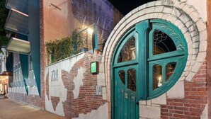 A building with a green door and a mural on the wall. - Green Door Lofts-Waco Rose - Silos/Downtown (Waco)