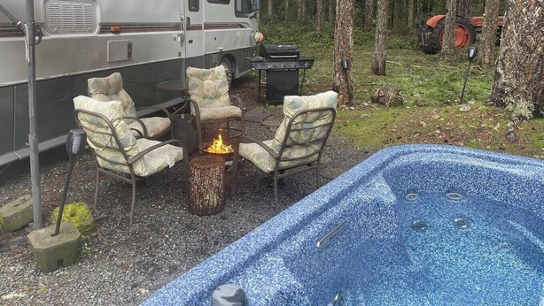 A recreational vehicle with a covered outdoor seating area, a hot tub, and a grill. - The Great Escape - Shirley (Sooke)