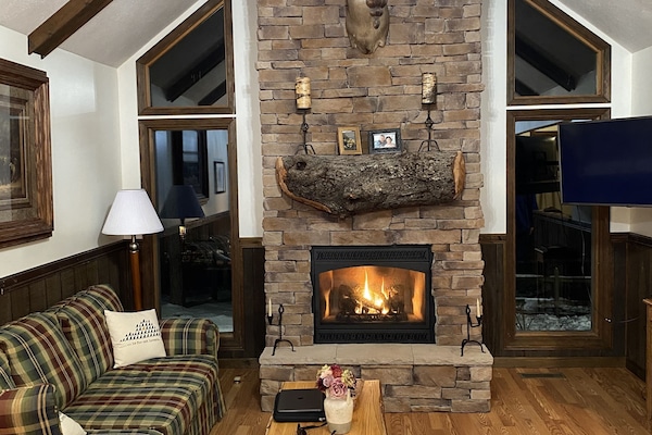 Living room at night with gas fireplace.