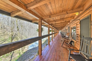 A wooden deck with a railing overlooking a forested area. - The Lodge Nantahala River<br>Bryson city, North Carolina.  Suite #1 (Bryson City)