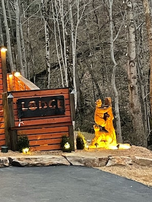 A lodge with a wooden exterior and a signboard.