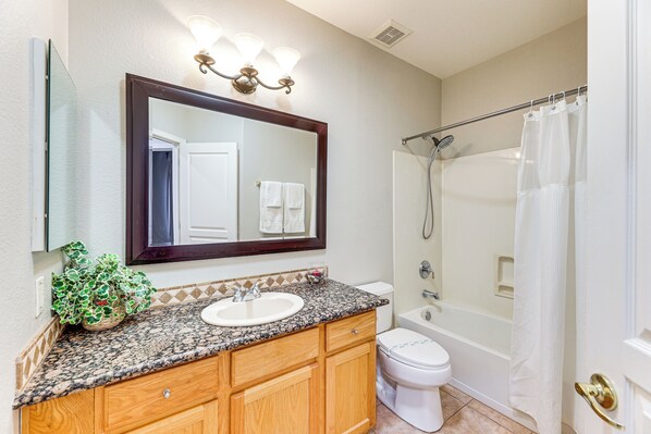 A bathroom with a sink, mirror, and shower. - Patio + Water View: Lakefront Chandler Escape! (Chandler)