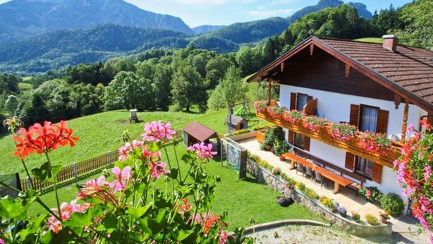 A chalet with a balcony, surrounded by lush greenery and mountains. - Vacation apartment Zuhaus- 2 persons, 45sqm, terrace with mountain view (Bad Reichenhall)