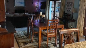 A dining area with wooden furniture, a rug, and a view into the kitchen. - Million Dollar Sunrise View (Batesburg-Leesville)