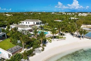 A coastal property with a large house, a swimming pool, and a beach. - Villa Cabuya | Contemporary Beachfront Luxury in Blue Cay Estate (Leeward Settlement)