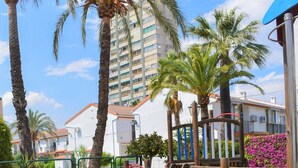 A playground with a slide, climbing structures, and a small table. - Ola Azul bungalow V (Benidorm)