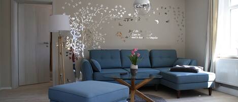 Deluxe Condo | Living area | Flat-screen TV