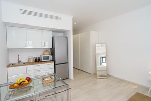 Fridge, microwave, coffee/tea maker, cookware/dishes/utensils