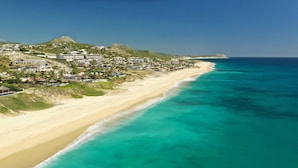 A coastal town with a beach, buildings, and a hill. - Luxurious 7 BR Beachfront Casa Oliver w/ WiFi, Pool, Home Theatre, Gym + More! (San Jose del Cabo)