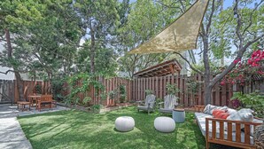 A backyard with a wooden deck, a covered seating area, and a lawn. - Venice Beach Cottage with incredible outdoor space!! (Venice)