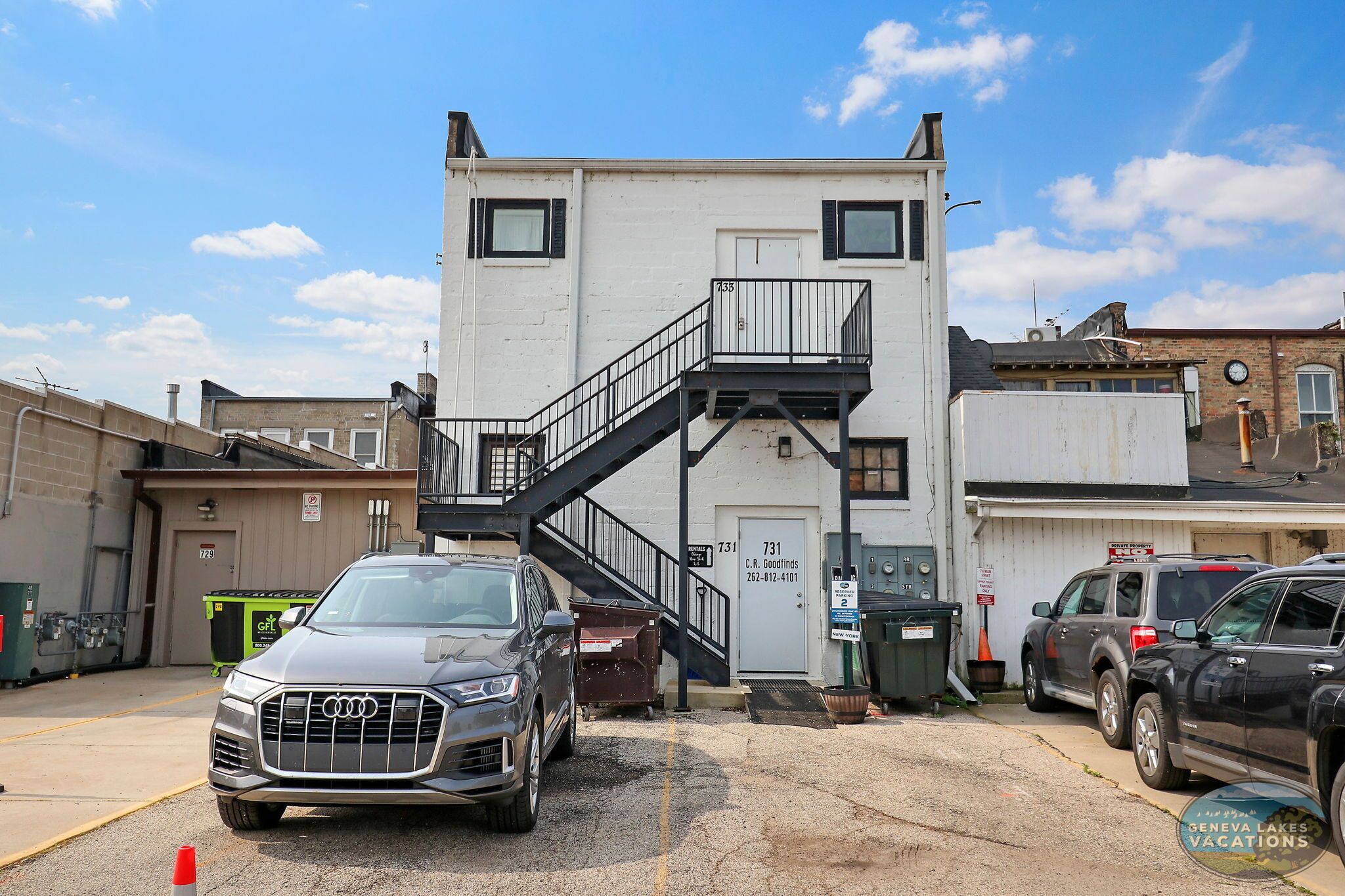 A building with a staircase leading to a door marked "731".